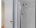 Shower featuring a shower head and white tiled walls, plus a glass shower door at 1334 Pelican Watch Villas, Seabrook Island, SC 29455