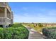 Scenic walkway showcases beautiful landscaping and offers a tranquil route to nearby beachside residences at 1334 Pelican Watch Villas, Seabrook Island, SC 29455