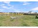 Large, fenced backyard overlooking a pond with chairs for enjoying the peaceful water view at 134 Ivory Shadow Rd, Summerville, SC 29486