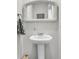 Classic bathroom pedestal sink with a vintage mirror and neutral paint create a timeless aesthetic at 134 Ivory Shadow Rd, Summerville, SC 29486