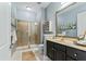 Bathroom showcasing a glass shower, large mirror, and dark vanity with elegant cabinet storage at 134 Ivory Shadow Rd, Summerville, SC 29486