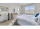 Bright bedroom features a blue-patterned bedspread, a window with natural light, and neutral-colored walls at 134 Ivory Shadow Rd, Summerville, SC 29486