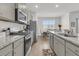 Modern kitchen with stainless steel appliances, granite countertops, and a view to the dining area at 134 Ivory Shadow Rd, Summerville, SC 29486