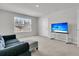 Relaxing living room with plush seating, a modern TV, and a view to the neighborhood at 134 Ivory Shadow Rd, Summerville, SC 29486