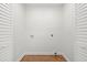 Empty laundry room offers hardwood floors, wainscotting accents, and hookups for washer and dryer at 1430 E Montague Ave, North Charleston, SC 29405