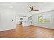 Sun-filled living room flows into a modern kitchen, featuring wood floors and a stylish ceiling fan at 1430 E Montague Ave, North Charleston, SC 29405
