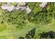 Aerial view showcasing the property next to the golf course, amidst trees at 146 High Hammock Villas, Seabrook Island, SC 29455