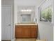 Bathroom featuring a vanity with granite countertop, a large mirror, and a bright window at 146 High Hammock Villas, Seabrook Island, SC 29455