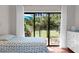 Bedroom showcasing a bed, dresser, and sliding glass doors with a scenic outdoor view at 146 High Hammock Villas, Seabrook Island, SC 29455