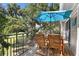 Relaxing outdoor deck with a table and chairs, perfect for enjoying the surrounding views at 146 High Hammock Villas, Seabrook Island, SC 29455
