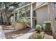 Inviting exterior of a tan condo building with stairs to the second-floor entry under mature tree canopy at 146 High Hammock Villas, Seabrook Island, SC 29455