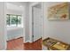 Hallway view leading into bedroom with wooden floors, nautical art, and a charming accent table at 146 High Hammock Villas, Seabrook Island, SC 29455