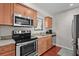 Kitchen with stainless steel appliances, granite countertops, and natural wood cabinetry at 146 High Hammock Villas, Seabrook Island, SC 29455