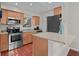 Compact kitchen featuring stainless steel appliances, granite countertops, and ample cabinet space at 146 High Hammock Villas, Seabrook Island, SC 29455