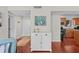 Bright living room featuring a stylish white cabinet for storage and hardwood flooring at 146 High Hammock Villas, Seabrook Island, SC 29455
