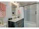 This bathroom showcases a tub/shower combo and a stylish vanity with marble countertops at 15 Dewey St, Charleston, SC 29403