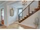 Welcoming foyer featuring a staircase with wrought iron railings and a decorative mirror at 15 Dewey St, Charleston, SC 29403