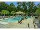 Relax at the community pool with lounge chairs, umbrellas, and inviting, clear blue water at 1529 Foster Creek Rd, Hanahan, SC 29410