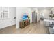 Bright living room with hardwood floors, a TV, and a stainless steel refrigerator at 1529 Foster Creek Rd, Hanahan, SC 29410