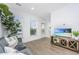 Well-lit living room featuring hardwood floors, and large windows at 1529 Foster Creek Rd, Hanahan, SC 29410