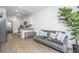 Cozy living room with a gray sofa, throw pillows, and modern lighting at 1529 Foster Creek Rd, Hanahan, SC 29410