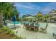 Resort-style pool area with ample seating, lounge chairs, and lush landscaping at 1529 Foster Creek Rd, Hanahan, SC 29410