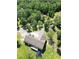 An aerial view of a home with a deck surrounded by lush greenery, ponds and trees at 153 Willow Brook Way, Cordesville, SC 29434