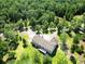 An aerial view of a home with a deck surrounded by lush greenery and trees at 153 Willow Brook Way, Cordesville, SC 29434