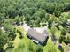 An aerial view of a home with a deck surrounded by lush greenery, ponds and trees at 153 Willow Brook Way, Cordesville, SC 29434