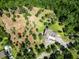 An aerial view of a home with a deck surrounded by lush greenery and trees at 153 Willow Brook Way, Cordesville, SC 29434