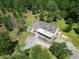 Aerial view of charming home featuring a large wrap-around porch and mature trees at 153 Willow Brook Way, Cordesville, SC 29434