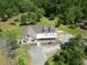 An aerial view of a charming home in a wooded setting with a large porch at 153 Willow Brook Way, Cordesville, SC 29434