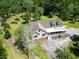 Aerial view of home exterior with covered front porch and lush landscaping at 153 Willow Brook Way, Cordesville, SC 29434