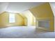 Spacious attic room with a window and built-in shelving, perfect for storage or conversion at 153 Willow Brook Way, Cordesville, SC 29434