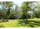 Expansive backyard surrounded by mature trees creates a serene and private setting at 153 Willow Brook Way, Cordesville, SC 29434