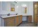 Bathroom with a double vanity, decorative mirrors, and a built-in dressing table at 153 Willow Brook Way, Cordesville, SC 29434