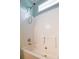 Bathtub with white tiling and a shower head and small window with natural light at 153 Willow Brook Way, Cordesville, SC 29434