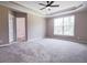 Spacious carpeted bedroom featuring large window, modern ceiling fan and tray ceiling at 153 Willow Brook Way, Cordesville, SC 29434