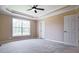 Bright bedroom with neutral carpet, large window, ceiling fan and en-suite door at 153 Willow Brook Way, Cordesville, SC 29434