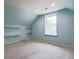 Bright bonus room featuring a window, carpeted floor and custom built in shelving units at 153 Willow Brook Way, Cordesville, SC 29434