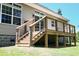Exterior shot of a new wooden deck with stainless steel railing and views of the yard at 153 Willow Brook Way, Cordesville, SC 29434