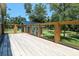 Spacious wooden deck with metal railing overlooks the backyard and shed at 153 Willow Brook Way, Cordesville, SC 29434
