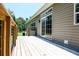 Backyard wooden deck with sliding glass doors offer access to the home at 153 Willow Brook Way, Cordesville, SC 29434