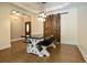 Dining room with a large wood table and an adjacent sliding barn door, illuminated by stylish pendant lights at 153 Willow Brook Way, Cordesville, SC 29434