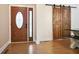 The entryway features a wooden door and wood-look floors, sliding barn door at 153 Willow Brook Way, Cordesville, SC 29434