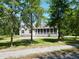 Serene view of a lovely home with a screened porch framed by mature trees at 153 Willow Brook Way, Cordesville, SC 29434