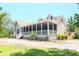 Charming home featuring a spacious screened-in porch and a sunny deck, ideal for outdoor living at 153 Willow Brook Way, Cordesville, SC 29434