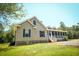 Charming home featuring a spacious screened-in porch, perfect for relaxing and enjoying the outdoors at 153 Willow Brook Way, Cordesville, SC 29434