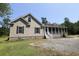 Attractive home featuring a large screened porch and well-kept lawn at 153 Willow Brook Way, Cordesville, SC 29434