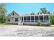 Charming home featuring a spacious screened-in porch, perfect for relaxing and enjoying the outdoors at 153 Willow Brook Way, Cordesville, SC 29434
